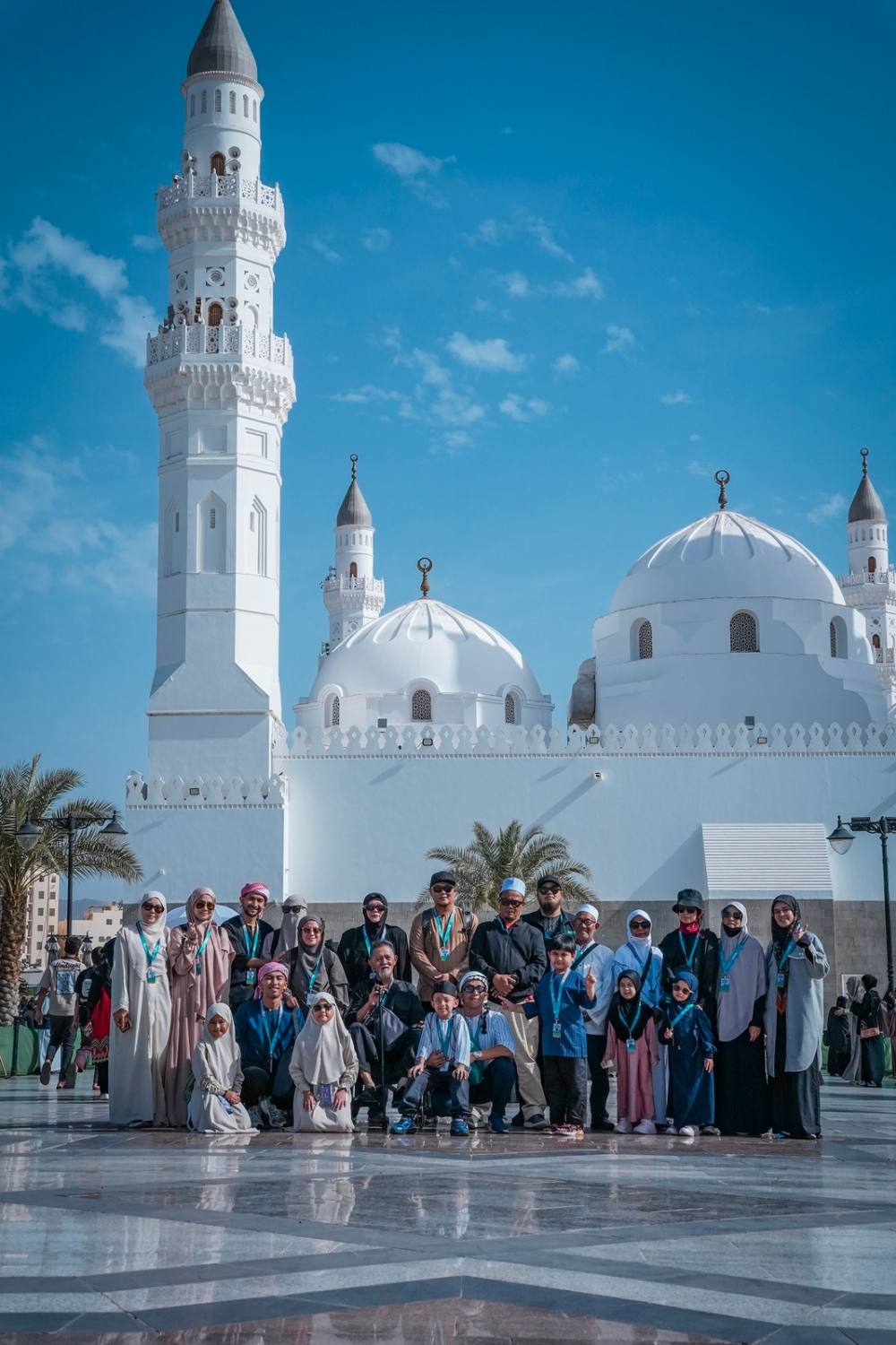 Crowd gathered in front of the white minaret of Quba' Mosque